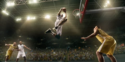 Fotobehang Basketball players on big professional arena during the game. Basketball player makes slum dunk © Alex