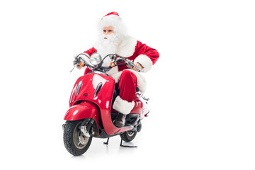 serious santa claus in costume riding on scooter isolated on white background