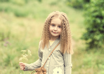 cute little girl is walking in summer