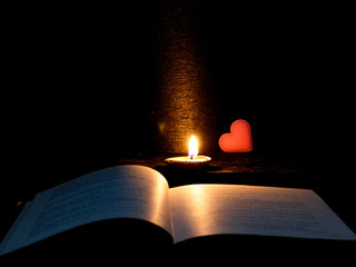 Open book and heart with lighting candle at night time,Back to School,Education concept,