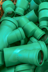 Connectors of plastic green water pipes of different sizes. Concept: prevention or technology