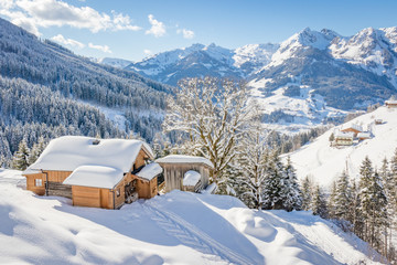 Beautiful winter mountain landscape with snowcapped wooden hut