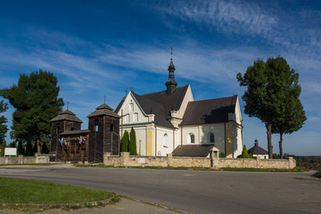 Fototapeta premium Church and larch gate in Krynki, Swietokrzyskie, Poland