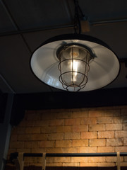 Light bulb lamp on brick board in the cafe.