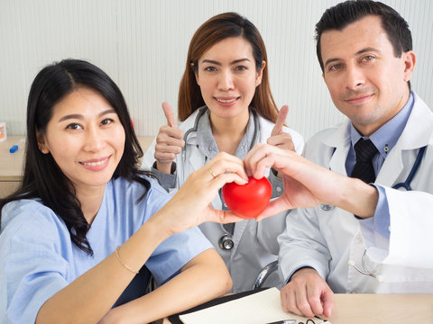 Healthcare Concept.Smiling Doctor And Patient Made Heart Symbol. The Patient Feels Hopeful, Happy And Safe.