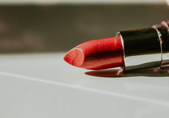 Red lipstick is on the table