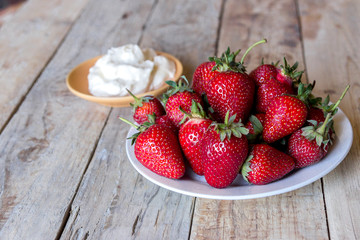 a delicious strawberry with sweet whipped cream