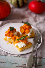 polenta crostini with butternut squash ricotta sage.selective focus