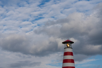 Kleiner Leuchtturm vor bew&ouml;lkten Himmel