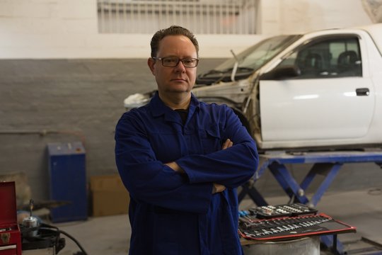 Male mechanic looking at camera