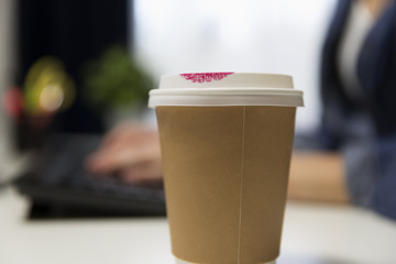 Cup of coffee with red lipstick.