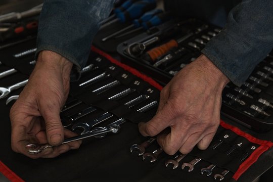 Mechanic arranging tools in garage