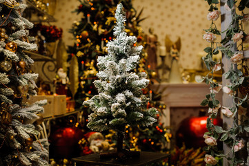 Little artificial Christmas tree decorated with artificial snow