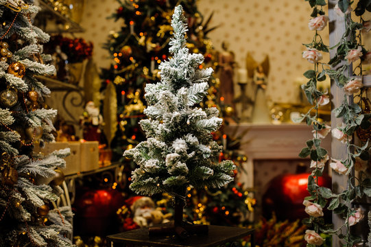 Little artificial Christmas tree decorated with artificial snow
