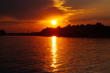 The sun is reflected on the waves, warm summer evening, romantic landscape, bright sunset on the...