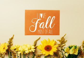 flat lay with beautiful flowers and orange card with 