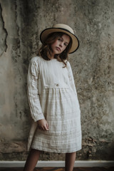 Beautiful girl in a hat. And white dress