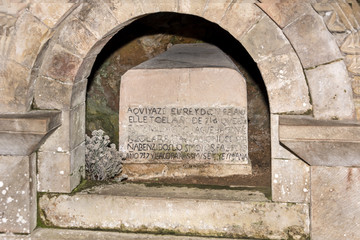 Spain, Asturias, Picos de Europa, Covadonga: Detail of an old sarcophagus next to the Virgin Mary shrine in the Hermitage of The Holy Cave of Covadonga (Santa Cueva) a famous Spanish sanctuary.