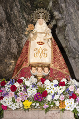 Spain, Asturias, Picos de Europa, Covadonga: Detail of Virgin Mary shrine in the Hermitage of The Holy Cave of Covadonga (Santa Cueva) a famous Spanish sanctuary - concept religion pilgrimage travel