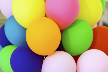 Fototapeta na wymiar Bright multicolored balloons close-up, festive abstract background for different themes