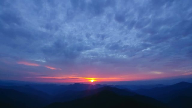 The beautiful mountain sunrise on the cloud stream background. time lapse