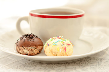 Cup of tea and  homemade cookies on white cloth