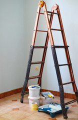 Freshly painted light blue room with painting equipments at home and ladder. Painting accessories are in an empty room.