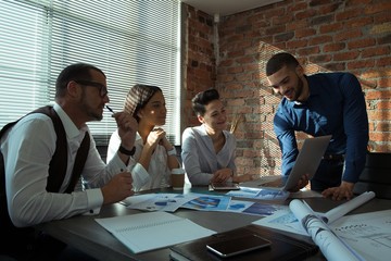 Executives discussing over laptop in conference room
