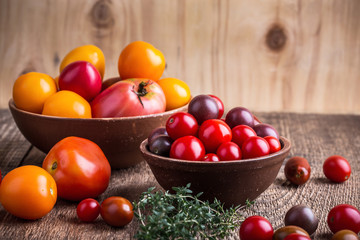 Colorful tomatoes on rural wooden table