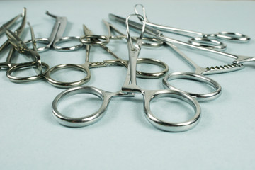 Medical surgical Instruments on blue background. Selective focus