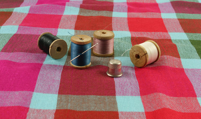 wooden spools with colored cotton threads for sewing, vintage