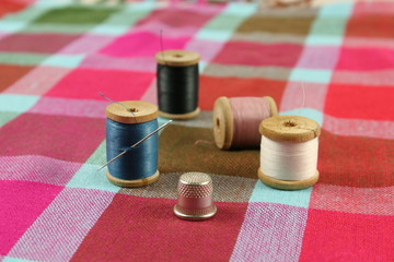 wooden spools with colored cotton threads for sewing, vintage