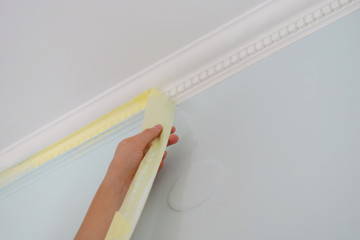 Remove paper masking tape from after painting. Removing masking tape from wall.