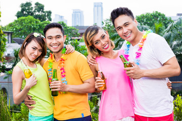 Happy pair of couple enjoying beer in the party at outdoors