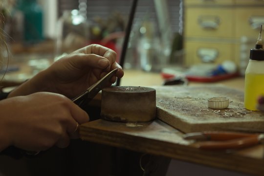 Jewelry designer making jewelry in workshop