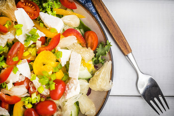 Salad with cheese and fresh vegetables.