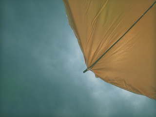 Yellow umbrella on blue sky