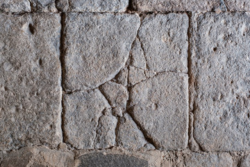 cracked stone block , antique tiled stone floor / wall with cracks