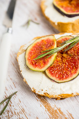 Bread with ricotta cheese, figs and honey on the wooden background. Shallow depth of field.