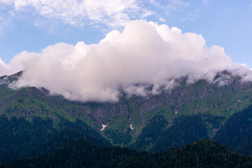 clouds on the peaks of the Caucasus mountains in summer