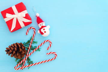 Christmas composition.  Red gift boxes with decoration on blue background.  Creative flat lay, top view design