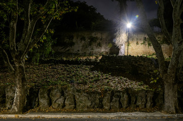 Night park with steps and a burning lantern