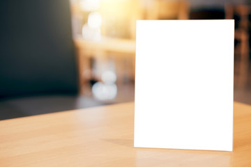 Mock up blank menu frame on table in coffee shop stand for your text of display your product