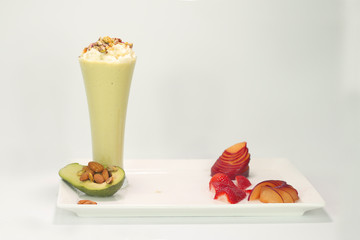 juice cup with fruit slices on a white plate with ice