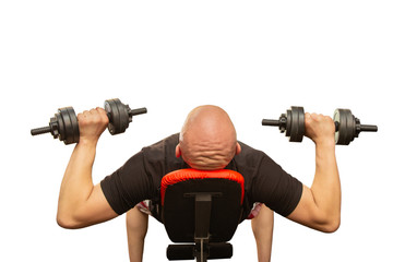 The bald man presses dumbbells from a breast.