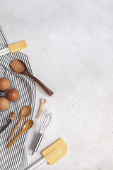 Kitchen utensils and ingredients for baking - Whisk, wooden spoons, silicone spatula, basting...