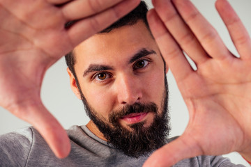Obraz premium portrait of black bearded handsome man with brown eyes in the studio on a white background