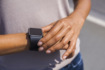 Woman's hand adjusting settings of smartwatch, close-up