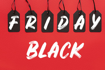 Obraz na płótnie Canvas black sale tags isolated on red with black friday lettering
