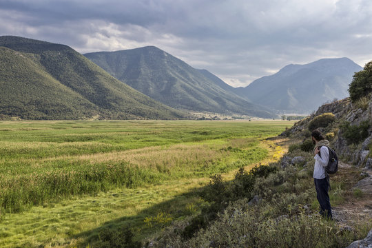 Greece, Peloponnese, Corinthia, Stymfalia, Ancient plateau, Lake Stymphalia, hiker looking at view